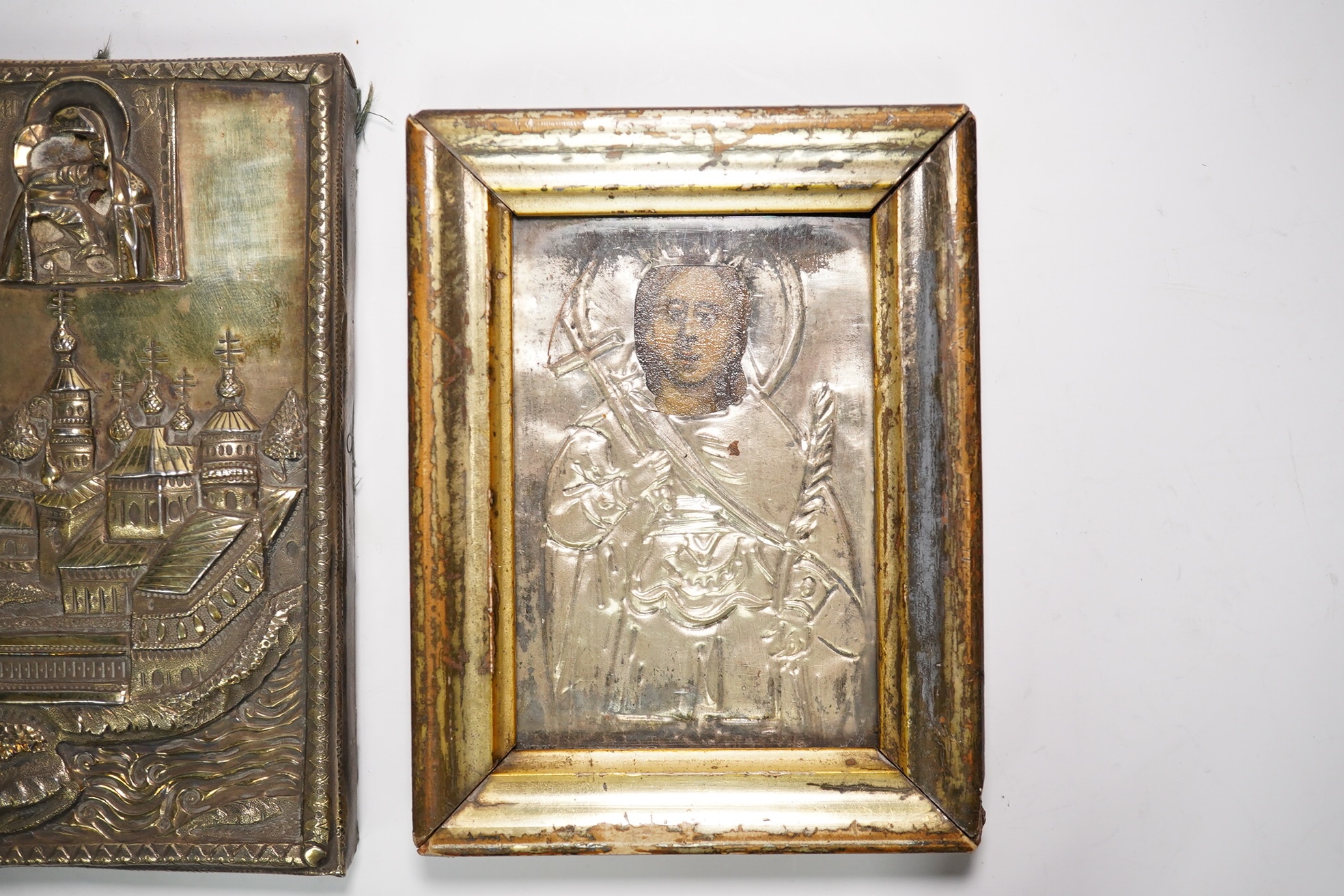 An 18th/19th century Russian silver overlaid icon together with another, largest 12 x 9cm. Condition - fair